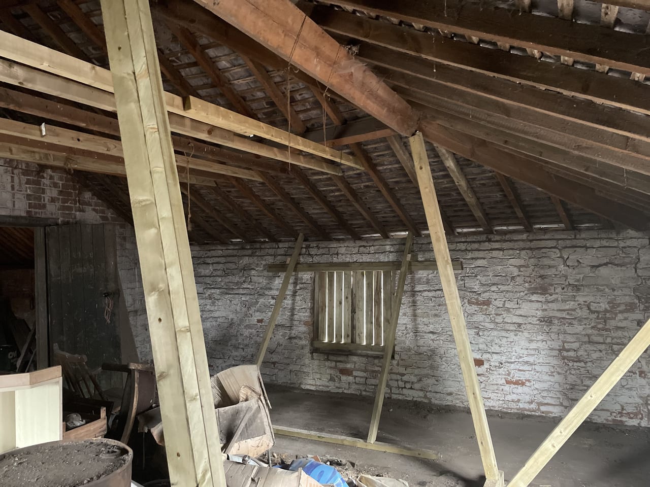 Bowing wall repaired with timber roof ties near Towcester