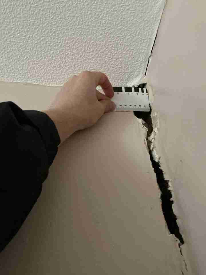Ceiling crack photographed during a structural wall crack inspection