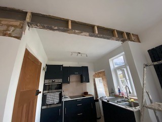 Exposed RSJ steel beam supporting an open-plan kitchen knock-through